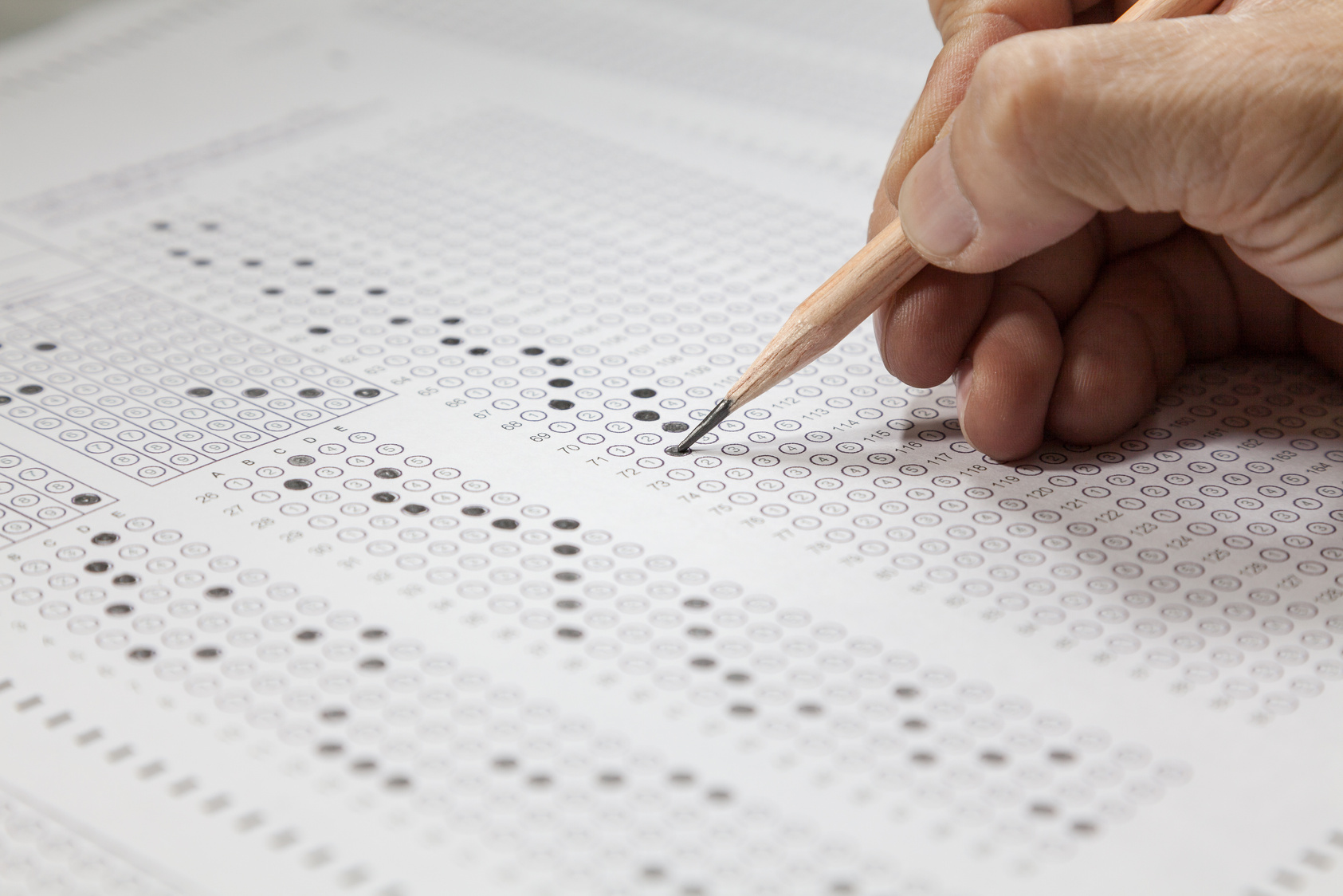 students hand doing exams quiz test paper